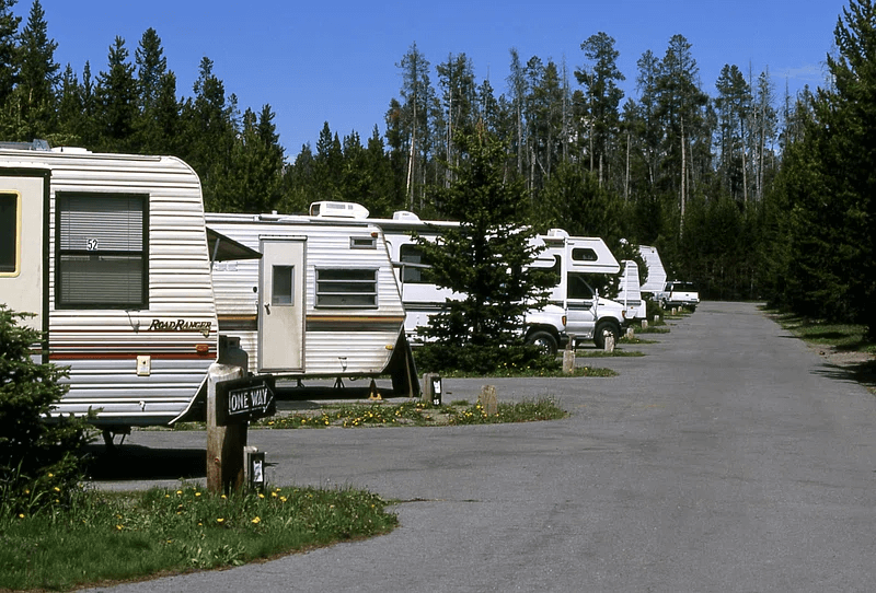 A family enjoying a summer camping trip in a seasonal RV site in Alberta